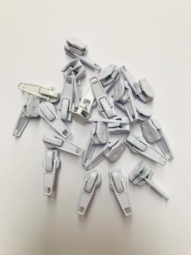 No 5 white plastic-coated metal zip pullers or ‘sliders’ are to suit our continuous zip. 