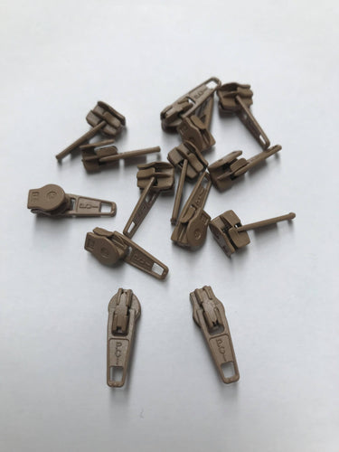 beige plastic-coated metal zip pullers / sliders